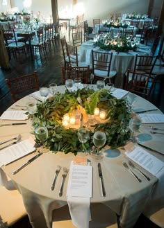 the table is set up with place settings for dinner and reception guests to sit at