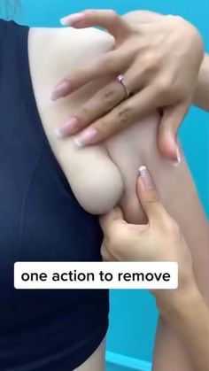 the woman is showing off her breast to another person with one ring on her finger