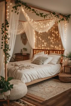 a bed with white sheets and lights on the headboard is surrounded by greenery