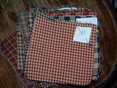 four pieces of cloth sitting on top of a wooden table