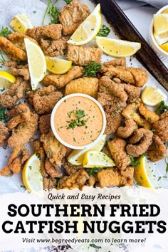 fried fish nuggets with dipping sauce and lemon wedges