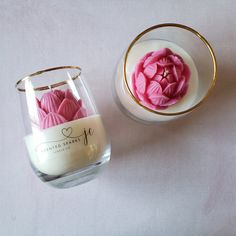 two vases filled with pink flowers next to each other