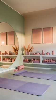 yoga mats and mirrors in a room with pink accents