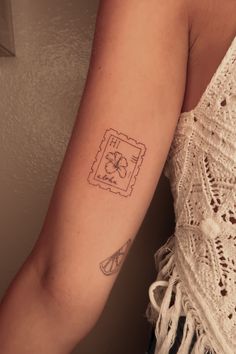 a woman with a small tattoo on her arm