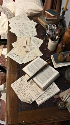 an old desk covered with papers and other items on top of it, including a pen