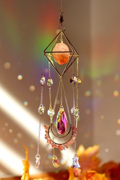 a wind chime hanging from the ceiling with beads and crystals