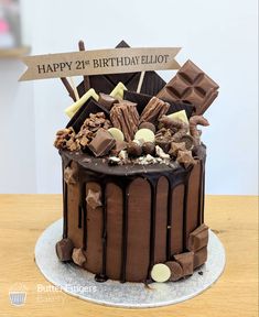 a birthday cake with chocolate and marshmallows on the top that says happy 21st birthday elliot