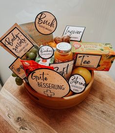 a wooden bowl filled with lots of different types of fruit and condiments on top of a table