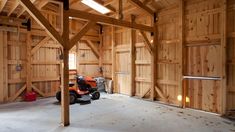 an empty garage with a lawn mower in it