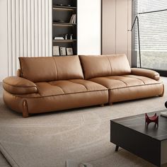 a brown leather couch sitting in front of a window