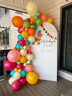 there is a sign with balloons attached to it