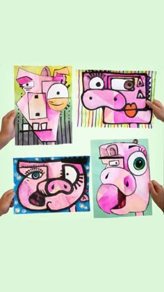 three people holding up paintings with animals painted on them, one in pink and the other in green