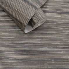 an upholstered wallpaper with grey and white stripes on it's surface