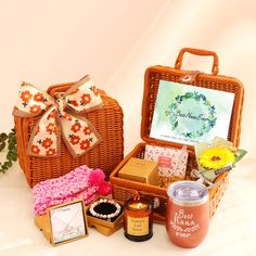 a wicker basket filled with lots of items next to a card and some flowers