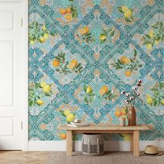 a wallpapered room with lemons and leaves on the wall next to a table