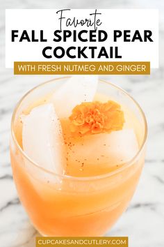 fall spiced pear cocktail with fresh nutmeg and ginger in a glass on a marble table