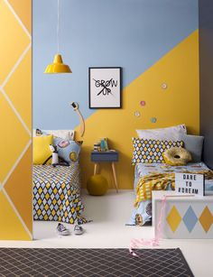 a child's bedroom with yellow, blue and white decor on the walls is shown