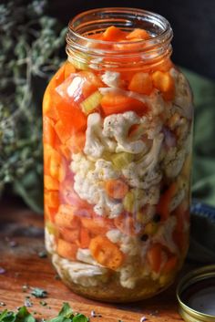 a jar filled with food sitting on top of a wooden table