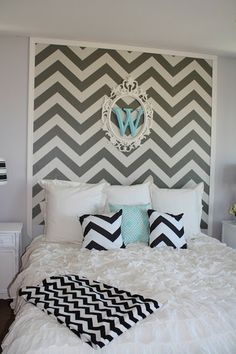 a white bed with black and gray chevrons on the headboard is featured in an instagram