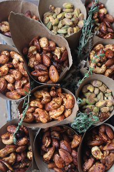 many different types of nuts in brown paper bags