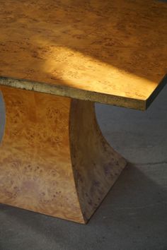 a wooden table sitting on top of a cement floor