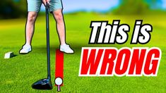 a man standing on top of a golf ball near a red marker that says, this is wrong