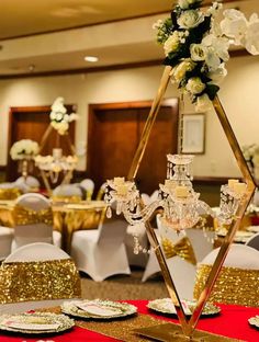 the tables are set up with gold sequins and white flowers in centerpieces