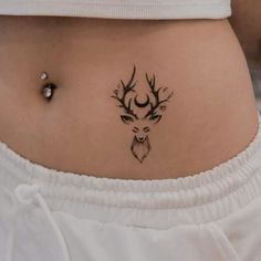 a woman with a deer tattoo on her stomach