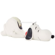 a white snoopy dog laying on its side