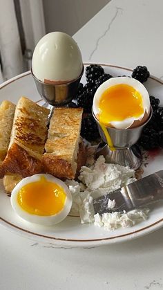 a plate with eggs, toast, and fruit on it