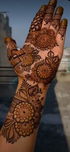 a woman's hand is decorated with hennap and intricate designs on it