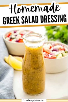 homemade greek salad dressing in a glass jar with lemon wedges on the side next to it