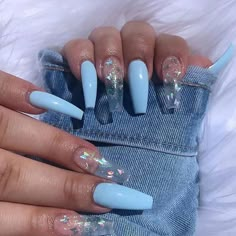 a woman's hands with blue and white acrylic nails