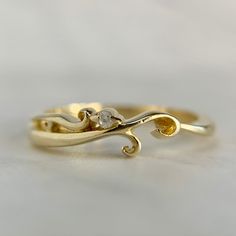 a gold ring with two diamonds on it