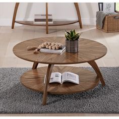 a coffee table with an open book on it and a potted plant in the middle