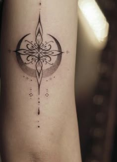 a woman's arm with a compass tattoo on the left side of her body