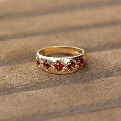 A super pretty vintage garnet five stone ring. The ring features five natural Mozabique garnets which have been star set in a solid 9ct yellow gold mount. A perfect everyday ring to stack alongside others or wear on its own. Band Width: Front- 6.5mm, Back 3.5mm Age: Vintage Metal: 9ct Yellow Gold Hallmarked: London 1978 Ring Size: P Weight: 2.8 grams Condition: Very Good (Rings over £300 can be resized free of charge. All rings under £300, please enquire about cost to resize) (Layaway available Garnet Rings Vintage, Vintage Ring Stack, Gold Garnet Ring, Everyday Ring, Everyday Rings, Garnet Ring, Funky Jewelry, Rings Cool, Garnet Rings