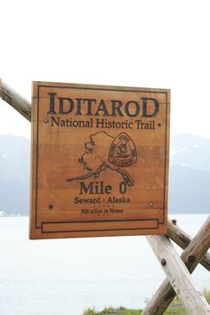 a sign for the iditaro national historic trail in front of some wooden poles