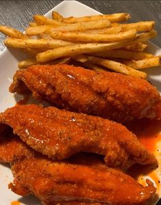 fried chicken and french fries on a plate with ketchup, sauce and mustard