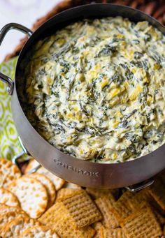 spinach dip in a bowl surrounded by crackers