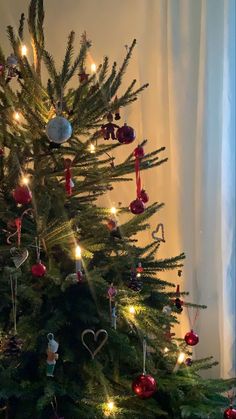 the christmas tree is decorated with ornaments and lights