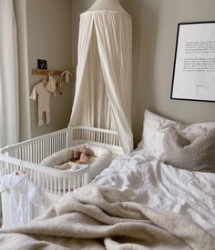 a white crib in the corner of a room with a teddy bear on it