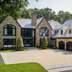 a large stone house with two garages