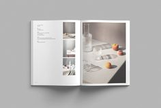 an open book with pictures of kitchen utensils and fruit on the countertop