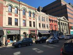 several cars are parked on the street in front of buildings