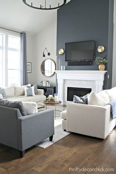 a living room filled with furniture and a flat screen tv mounted on the wall above a fireplace