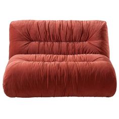 an orange futon chair with the seat cushion folded back and foot rests on it's side