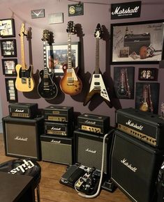 guitars and amps are lined up on the wall in this music studio with purple walls