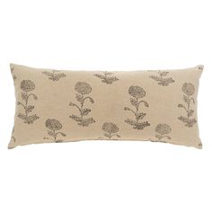 a beige pillow with black flowers on the front and back, sitting on a white background