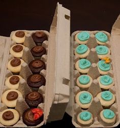 two open boxes filled with cupcakes on top of a table